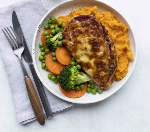 Chicken Parmigiana on sweet potato mash with vegetables