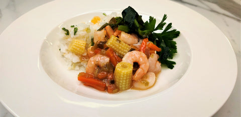 Prawns with sweet & sour sauce on fried rice with baby corn and greens